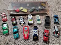 Overall lot: Jaguar display case and 14 loose cars on carpet