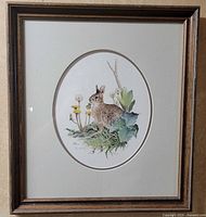 Framed oval-matted rabbit print in wood frame