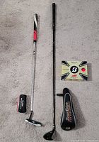 Putter, 5-wood, both headcovers and sealed Bridgestone ball box laid out