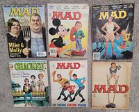 Six humor magazines displayed front covers visible