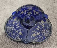 Top view of lid showing sterling silver floral overlay and loop handle