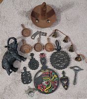 Full lot overview of assorted cast iron items, bells, and openers