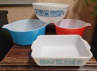 Group shot of four Pyrex pieces showing colors, shapes, and patterns