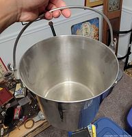 Interior view of stainless steel pail showing handle attachment and wear