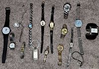 Overview of all sixteen wristwatches on carpet