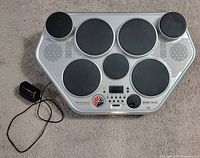 Top view of Yamaha DD-55 showing all seven pads and power adapter