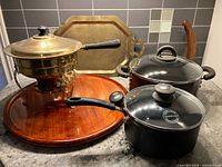 Overall lot showing chafing dish on wood base, brass tray, two black pots with lids