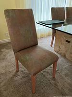 Full view of one Parsons chair showing upholstery, backrest, seat and wooden legs