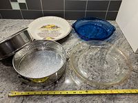 Five baking pieces laid out on countertop