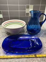 Blue glass pitcher, platter, ceramic pasta bowl