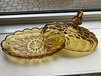 Amber pressed glass butter dish open, showing lid and base details