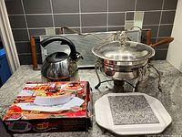 Group shot of kettle, chafing dish, warming tray, trivet and box