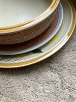 Stacked view of bowl and two plates showing colors and patterns