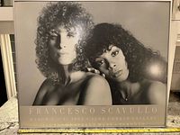 Full view of framed black-and-white Francesco Scavullo poster showing text and imagery