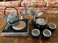 Group shot of books, teapots, cups, bowl, vase