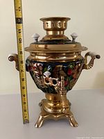 Full view of brass and enamel samovar with ruler showing 12in height