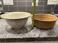 Both bowls side by side with measuring tape showing heights