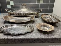 All five silver-plate pieces grouped together