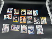 Overview of all 16 Wayne Gretzky cards spread on black background