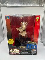 Front of boxed Qui-Gon Jinn talking coin bank