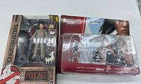 Ghostbusters Podcast figure pack beside Mirror's Edge Catalyst 3-pack