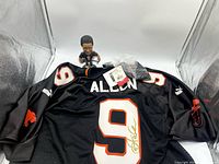 Full view of signed jersey with bobblehead and tags
