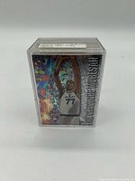 Front view of clear plastic card box showing SkyBox Mission Accomplished Gheorghe Muresan insert card