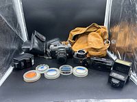 Group shot of all cameras, flashes, filters, bags