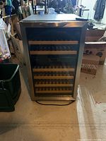Front view of Danby wine cooler with glass door and wooden racks