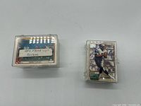 Two plastic card cases of football cards side by side