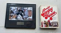 Framed hockey photograph and hardcover book side by side
