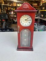 Full view of wooden clock-shaped jewelry box closed