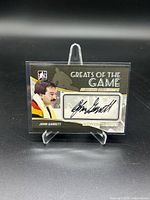 Front of John Garrett signed trading card in stand