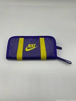 Front view showing purple exterior, yellow stripes and Nike logo
