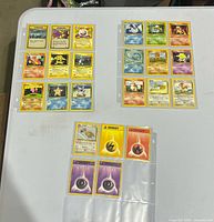 Overview of three binder pages showing all 23 cards on tabletop