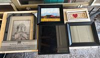 All five picture frames arranged on tabletop
