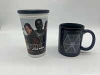 Front view of Rogue One plastic cup beside black ceramic TIE Fighter blueprint mug