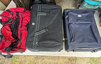 Overview of three suitcases on table showing sizes and colours