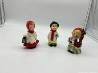 All three ceramic caroler figurines front view