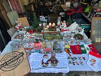 Overview of entire assortment of vintage Christmas decorations displayed on table