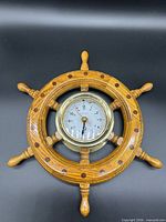Front view of oak ship’s wheel clock showing overall design