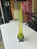 Full view of green swung vase on table