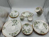 Group shot showing entire set including plates, bowls, teacups, creamer, sugar and serving platters