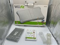 All items including boxed balance board, game case, sealed mat, and sleeves