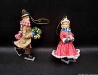 front view of both ceramic ice-skating couple ornaments