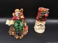 Seated Santa figurine and Santa head candle holder side by side