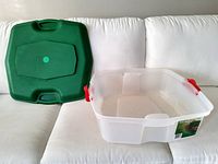 Clear plastic box with green lid separated, view of exterior