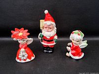 Front view of three ceramic Christmas figurines