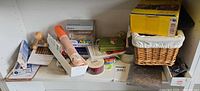 Shelf view with Rosetta Stone box, basket, ribbon rolls, USB hub and assorted supplies