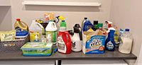 Wide view of entire lot on countertop showing multiple cleaning products